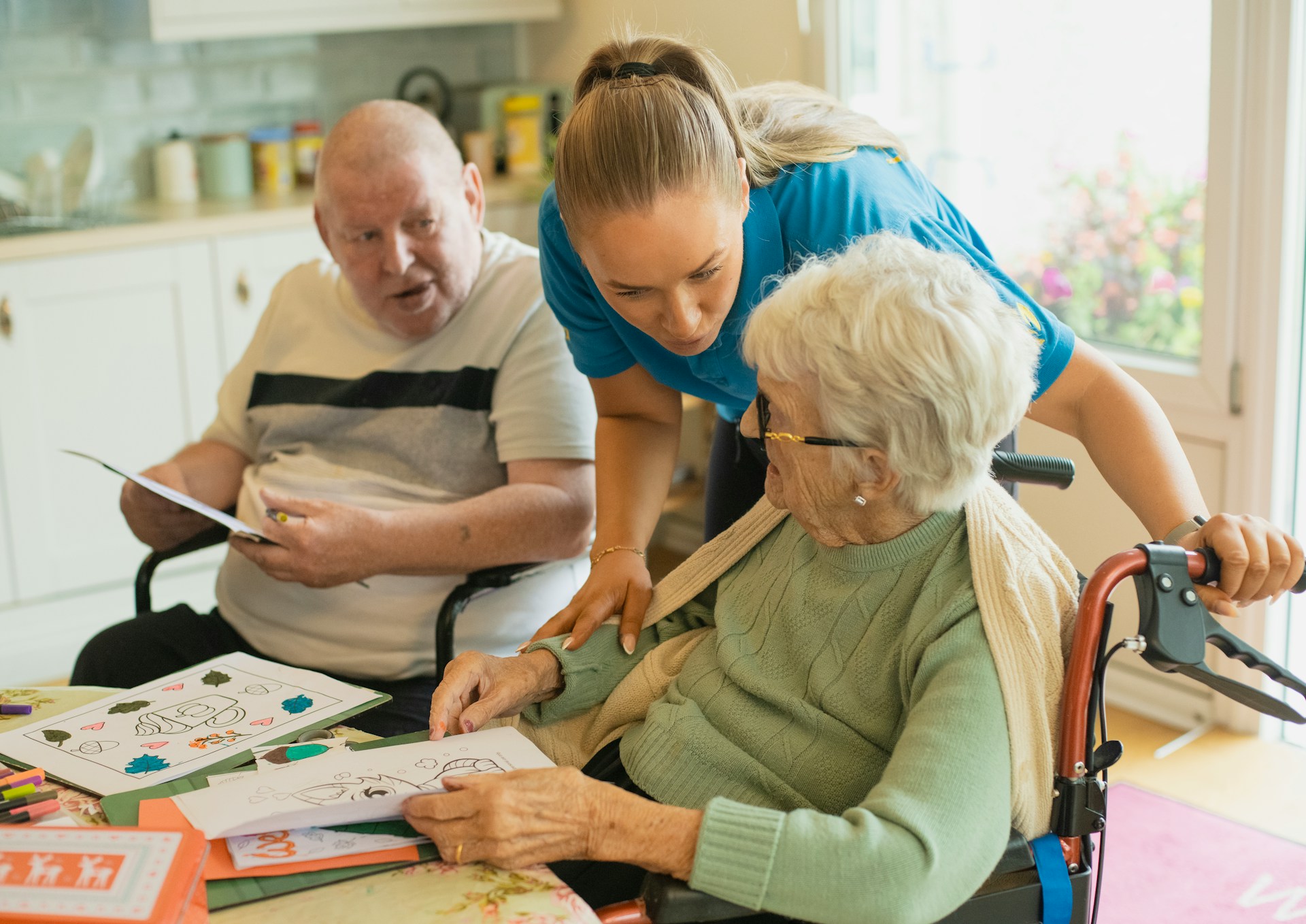 A support worker sitting with an older person, listening