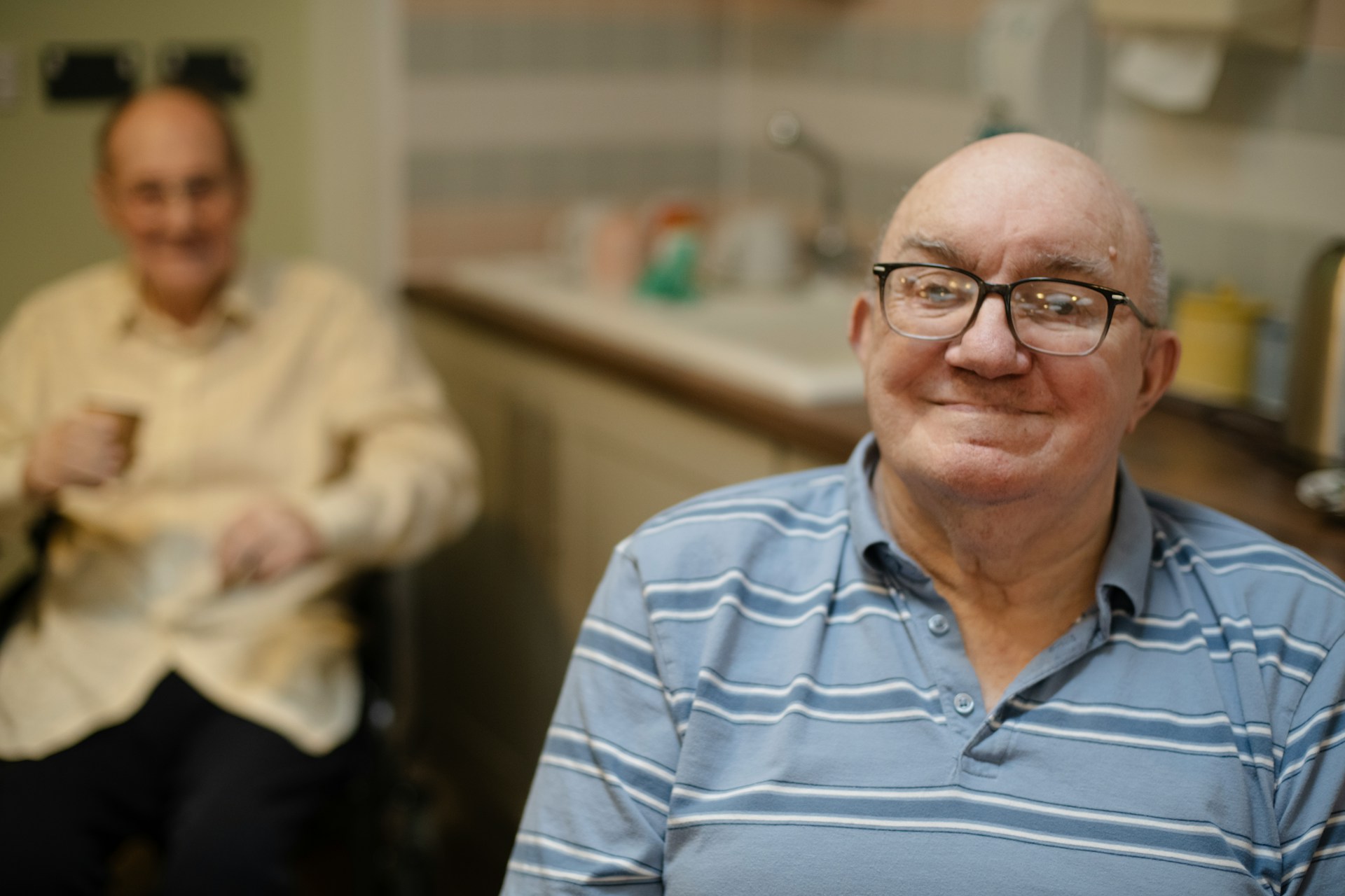 An older person's hands being held by a carer